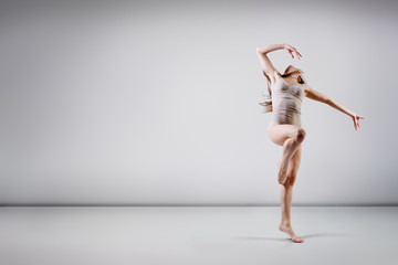 young beautiful dancer teen girl dancing and jumping, studio ser