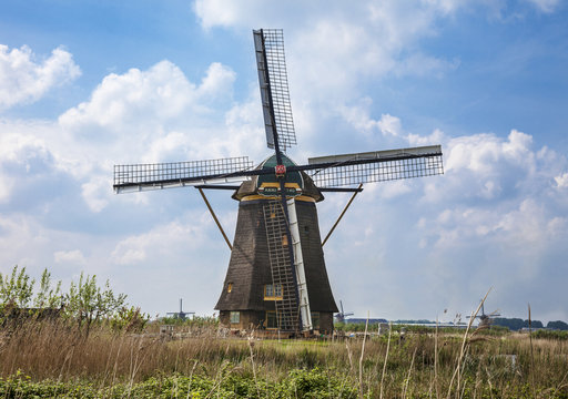 Picturesque landscape with windmills