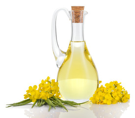Rapeseed oil and flowers isolated over white. - obrazy, fototapety, plakaty