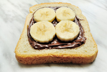 Bread with chocolate cream and slices of banana