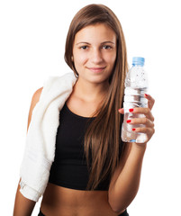 pretty young sporty woman holding a water glass and a towel on w