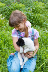 little girl playing with small  puppiy