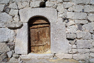Fototapeta na wymiar Wooden door and stone wall