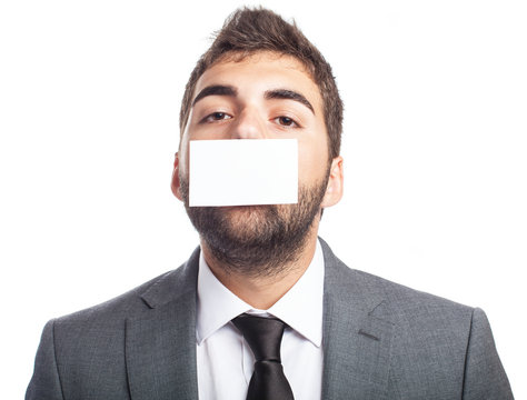 Portrait Of Business Man With Mouth Covered With A Paper Card