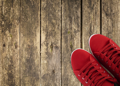 red sneakers on wooden deck - Powered by Adobe