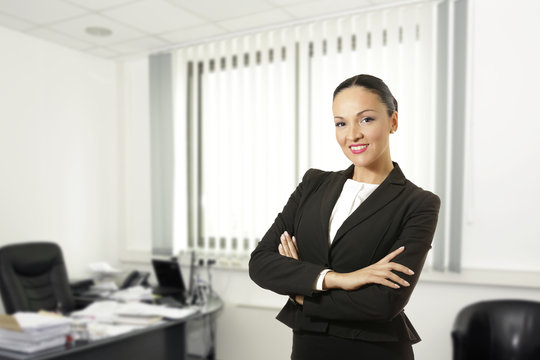Successful young business woman inside her office.