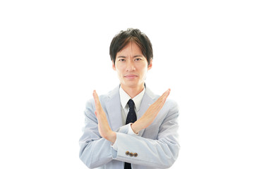 禁止の意思表示をするビジネスマン