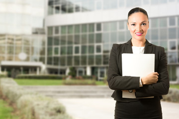 Business dressed woman standing in front of the building.