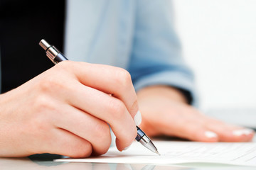 Female hand signing contract