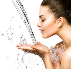 Beautiful model woman with splashes of water in her hands