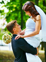 Bride and groom with flower outdoor.