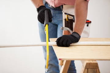 Plumber using a hacksaw