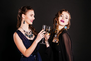 two young women with glasses of champagne