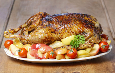 Roasted goose on wooden table