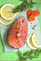 Raw salmon on the green background.