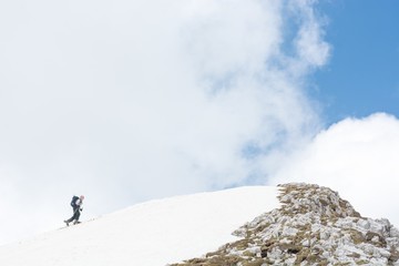 Skiier reaching mountain top