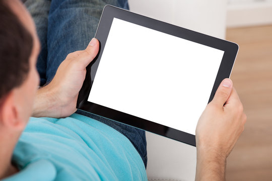 Man Looking At Blank Screen Of Digital Tablet