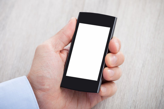 Businessman's Hand Holding Smartphone With Blank Screen