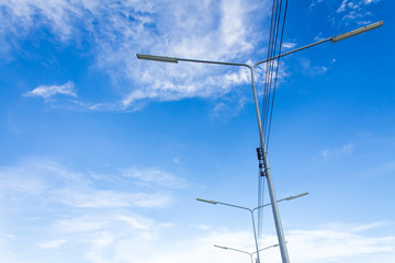 Electric lighting system tower on blue sky background