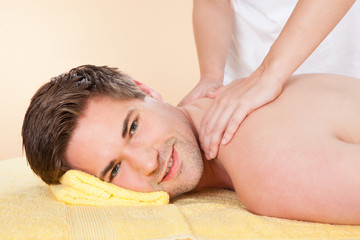 Fototapeta na wymiar Man Receiving Back Massaging In Spa