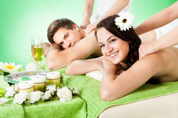 Obraz na płótnie Canvas Smiling Couple Receiving Shoulder Massage At Beauty Spa