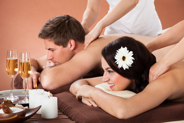 Obraz na płótnie Canvas Relaxed Couple Enjoying Shoulder Massage At Spa