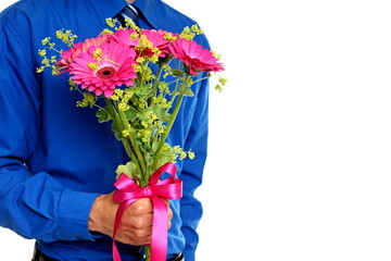 Man in blue shirt holds flowers Gerbera flower