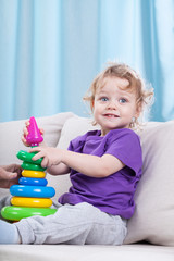 Naklejka premium Little child playing with toys