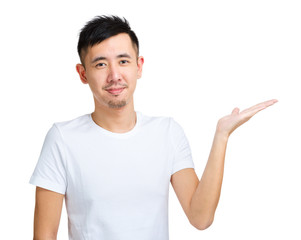Young man with hand showing something