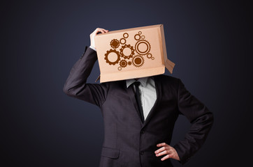 Young man gesturing with a cardboard box on his head with spur w