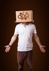 Young man gesturing with a cardboard box on his head with spur w