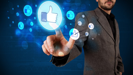 Handsome person pressing thumbs up button on modern social netwo