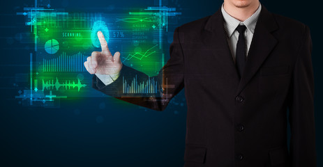 Young businessman pressing modern technology panel with finger p