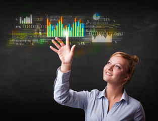 Young business woman touching colorful charts and diagrams