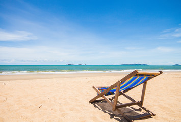 Fototapeta na wymiar Canvas chair on beach and blue sky