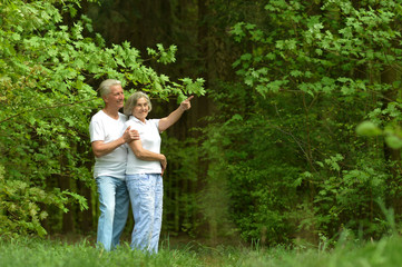 elderly couple rest on the nature