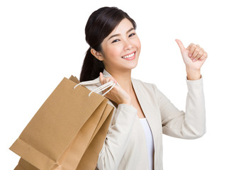 Asian woman thumb up and holding with paper bag