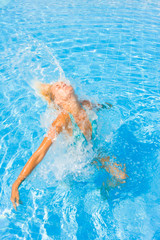 Woman enjoying the summer at the swimming pool