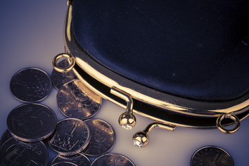 Black vintage wallet and coins isolated on white