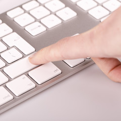 silver keyboard with woman finger