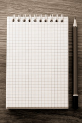 checked notebook on wood