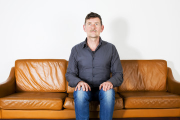 Fototapeta premium man itting on couch