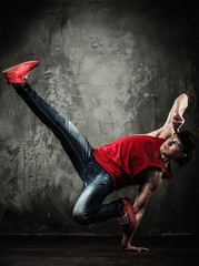 Man dancer showing break-dancing moves
