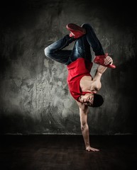 Man dancer showing break-dancing moves