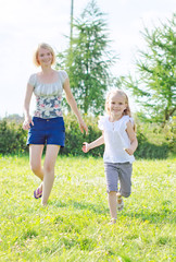 Fototapeta premium Happy family having fun at the park.