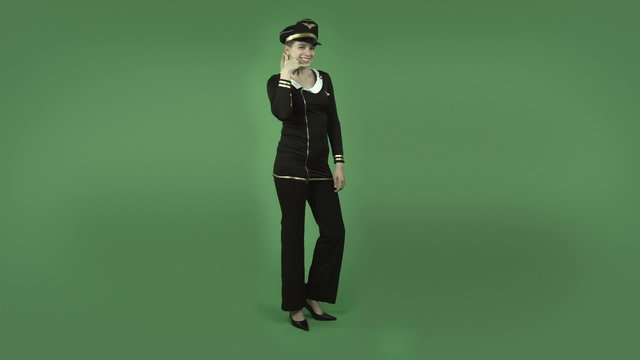 attractive caucasian air hostess isolated on green with call me