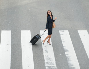 Businesswoman crossing street at crossway