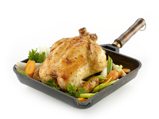 Whole roasted chicken with vegetables on the white backround