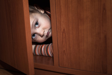 Scared child hiding