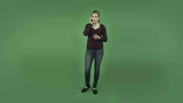 attractive casual caucasian girl isolated on green upset on cell
